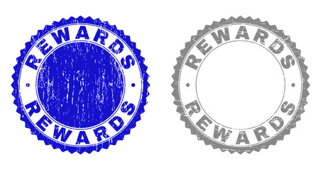 Grunge REWARDS stamp seals isolated on a white background. Rosette seals with grunge texture in blue and grey colors. Vector rubber stamp imitation of REWARDS title inside round rosette.