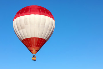 Beautiful view of hot air balloon in blue sky. Space for text