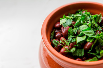 lobio is a Georgian national dish.Lobio,  on white background, view from above.Boiled georgian beans or Lobio in a clay pot 