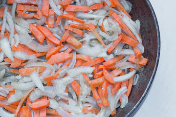 Fying pan with vegetables. Frying pan  with carrot and onion. Fresh carrots and onion  close up.