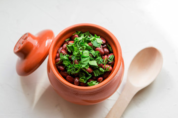 lobio is a Georgian national dish.Lobio,  on white background, view from above.Boiled georgian beans or Lobio in a clay pot 