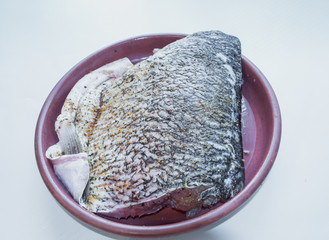 Pickled silver carp. Preparing for cooking. Fresh fish at the plate. Fish cook at home.