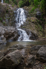 Landscape with an idyllic waterfall in the rainforest and a natural pool