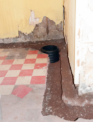 An open french drain pit and sump pump basin prior to being filled with stones and  covered with...
