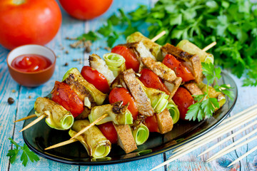 Vegetarian snack kebabs - slices of cherry tomatoes, zucchini and bread baked on wooden skewers