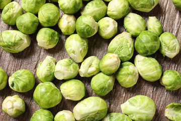 Fresh Brussels sprouts on wooden table, top view