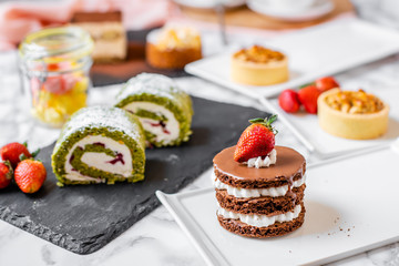 delicious strawberry and mint cakes on a white and black plate