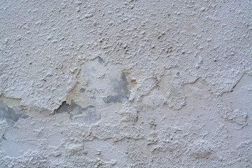 Texture of old concrete wall covered with white plaster
