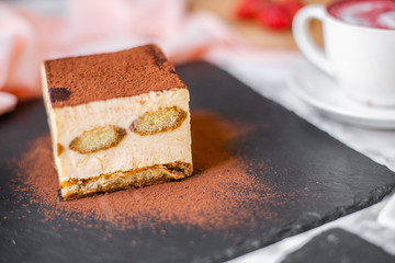 delicious tiramisu on a black plate