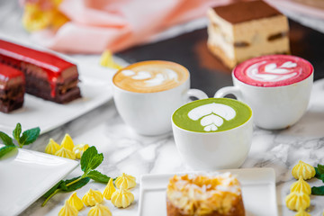 delicious composition of latte tea with cakes