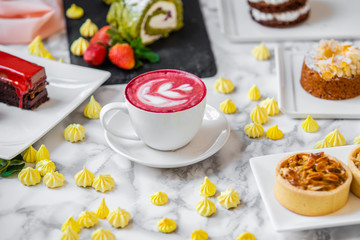 delicious composition of latte tea with cakes