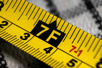 Yellow Tape measure showing measurement in metres and feet