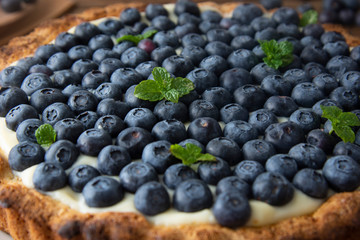 Blueberry Tart or cake with cream and berries. Fresh sweet dessert with fruits. homemade food, wooden, rustic background.