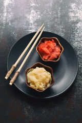 Pickled ginger slices and wooden chopsticks. Ingredient for sushi. Healthy food. Traditional Japanese condiment.