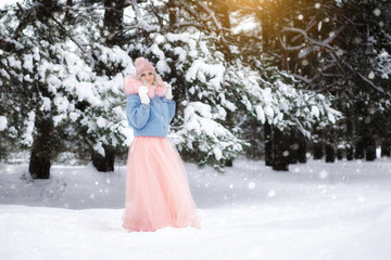 portrait of a beautiful girl on a walk in the winter forest.