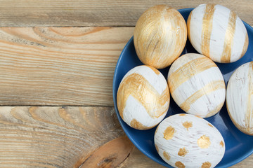 Happy Easter. Painted eggs on wooden table. Top view.