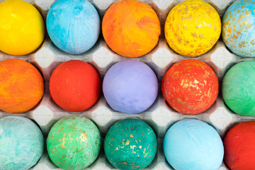 Happy Easter card. Colorful shiny easter eggs on wooden background. Copy space for text.