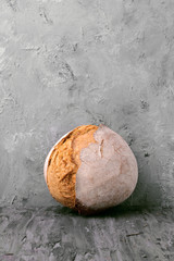 rustic loaves of bread supported on gray marbled background