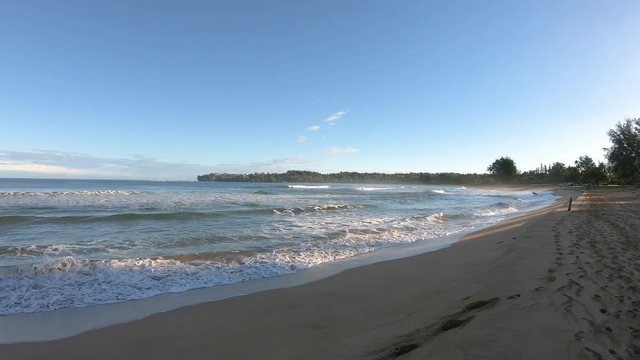Timelapse in 4K of the waves onto sand at sunrise in Hanalei Bay on hawaiian island of Kauai