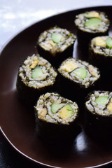 Sushi from cauliflower, avocado and tuna. Traditional Asian food. Diet healthy food concept. Cereal free. Gluten free. Dairy free. AIP Autoimmune Paleo.