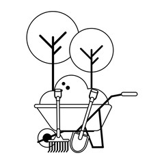 wheelbarrow with ground and harvest tools black and white