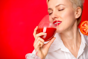 woman with a glass of red tomato juice. Healthy lifestyle concept