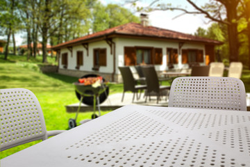 White table background of free space and grill time in garden 