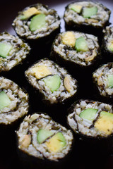 Sushi from cauliflower, avocado and tuna. Traditional Asian food. Diet healthy food concept. Cereal free. Gluten free. Dairy free. AIP Autoimmune Paleo.