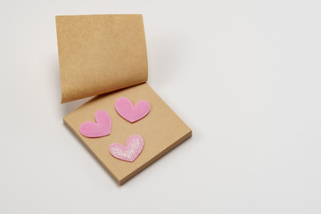 Sticky brown paper notes with a heart. On a white background. Valentine's Day