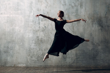 Ballerina female. Young beautiful woman ballet dancer, dressed in professional outfit, pointe shoes and black tutu.