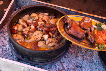Preparing food outdoor for many people, direct on fire in a big pot.
