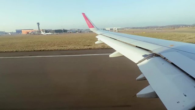 View from the airplane window during takeoff in sunny February weather