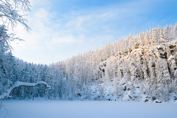 Icy lake, snow and a mountain in a sunset