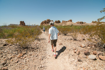The kids on the trail during a hike in a Texas desert