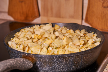 Potatoes with spices fried in a pan