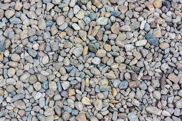 Natural colorful pebble (stones) background texture with copy space.