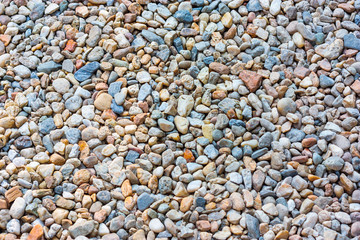 Natural colorful pebble (stones) background texture with copy space.