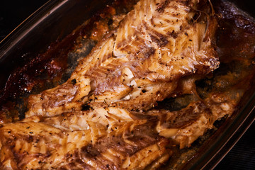 Baked fish with onions and spices. Macro mode