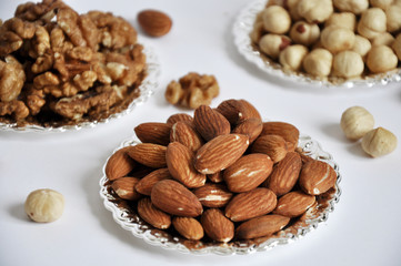 mixed nuts in a bowl isolated on white background