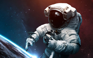 Astronaut against Earth planet. Science fiction art. Elements of this image furnished by NASA