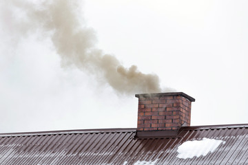 Smoke coming out of the house chimney