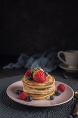 Delicious american pancakes with berries. Vertical. Copyspace