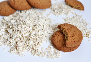 oatmeal cookies and oats on white background
