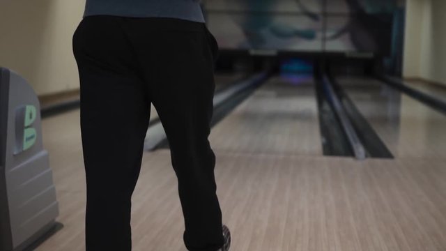 Guy throws a bowling ball