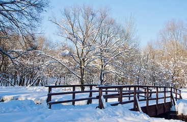 wooden bridge in a city park on a winter day