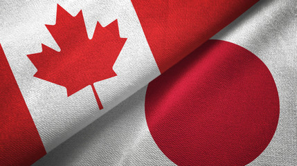 Fototapeta na wymiar Canada and Japan two flags textile cloth, fabric texture