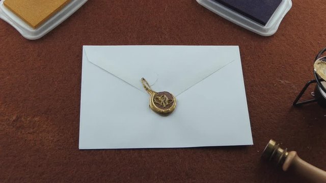Zoom in getting closer to a letter sealed with golden wax using the medieval way