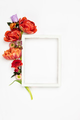 White vintage frame and flowers on a white background