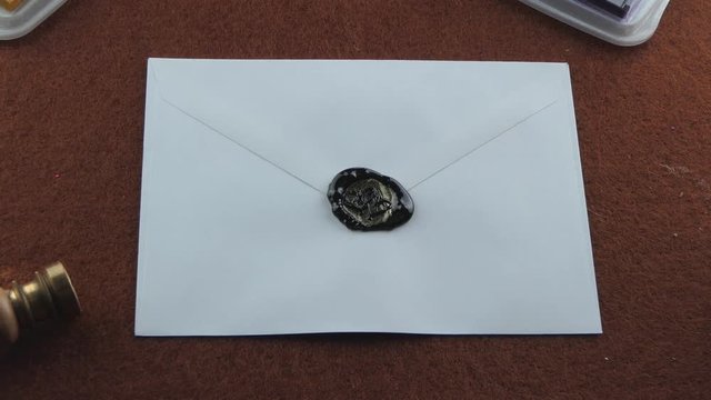 Zoom in getting closer to a letter sealed with black wax using the medieval way