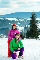Fototapeta na wymiar Portrait of a lover of a pair of skiers in an outfit on the top of the Carpathian Mountains